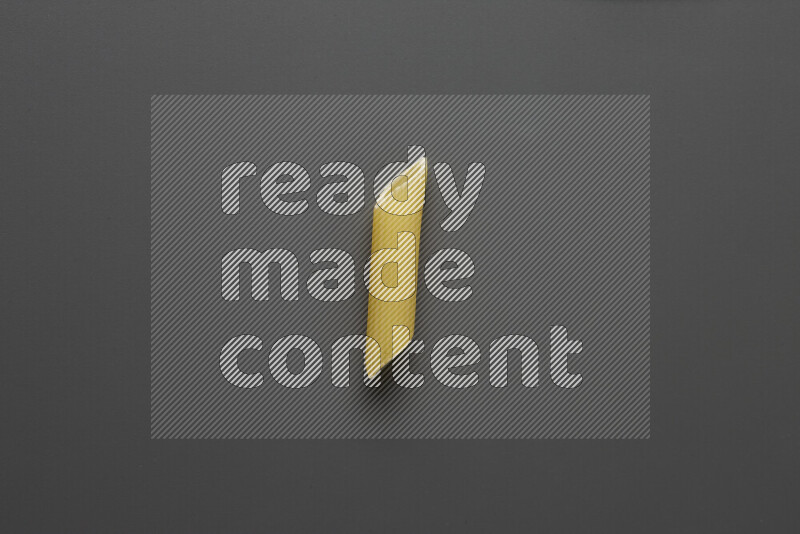 Penne pasta on grey background