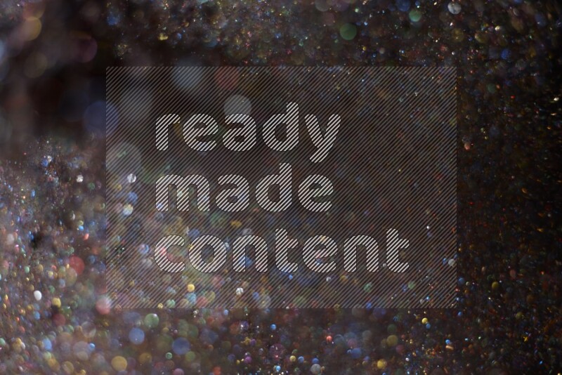 Multicolored glitter powder isolated on black background