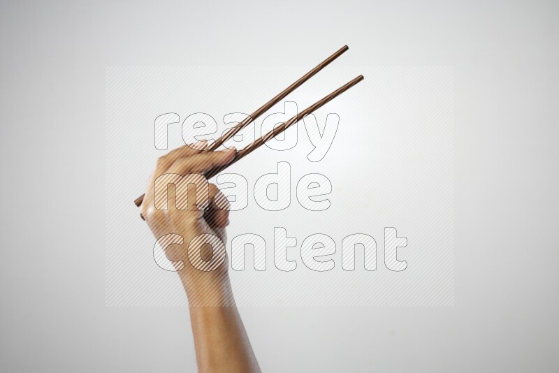 Male Hand Holding Chop Stick on white background