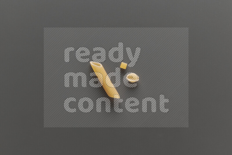 Different pasta types on grey background