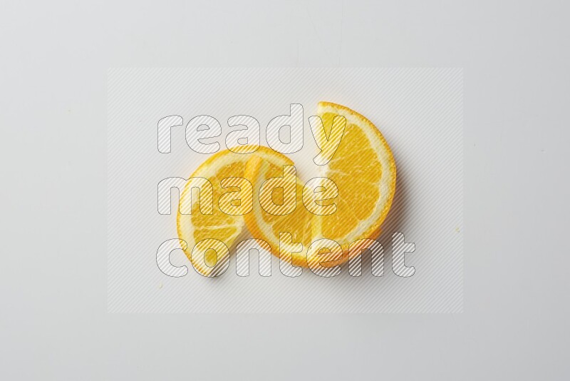 Three halves of an orange slices on white background