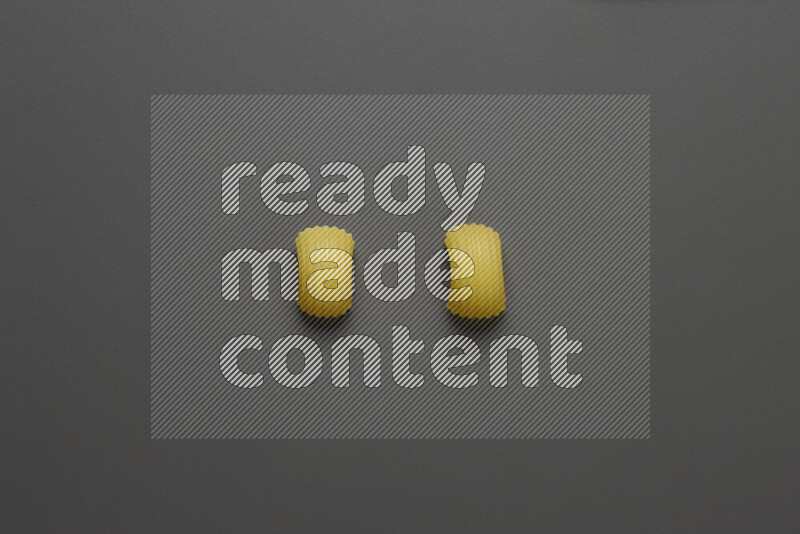 Elbow pasta on grey background