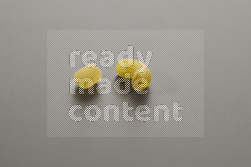 Big rings pasta with other types of pasta on grey background