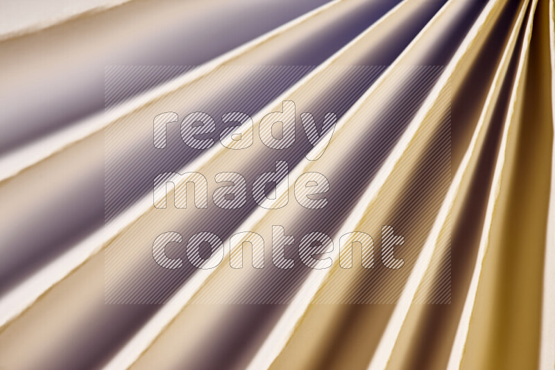 An image presenting an abstract paper pattern of lines in white and gold tones