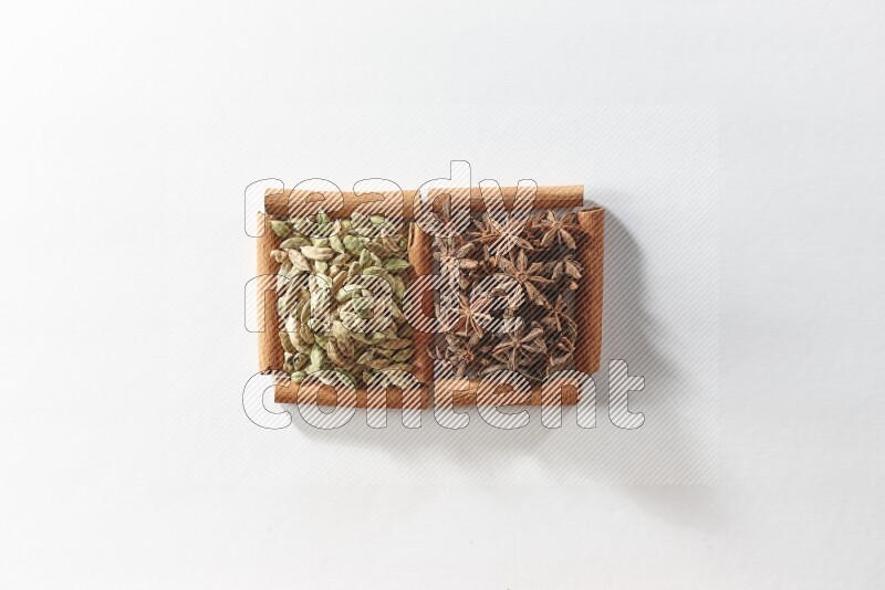 2 squares of cinnamon sticks full of star anise and cardamom on white flooring