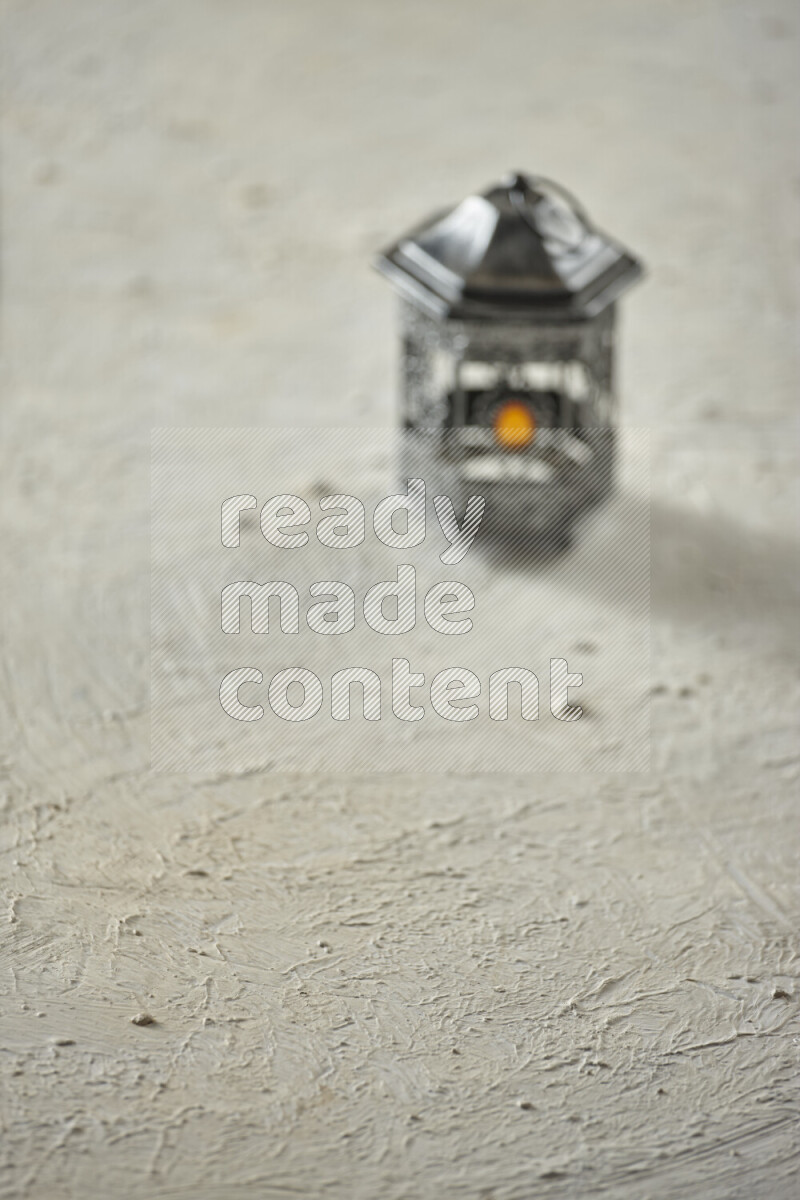 A lantern placed on a textured white background