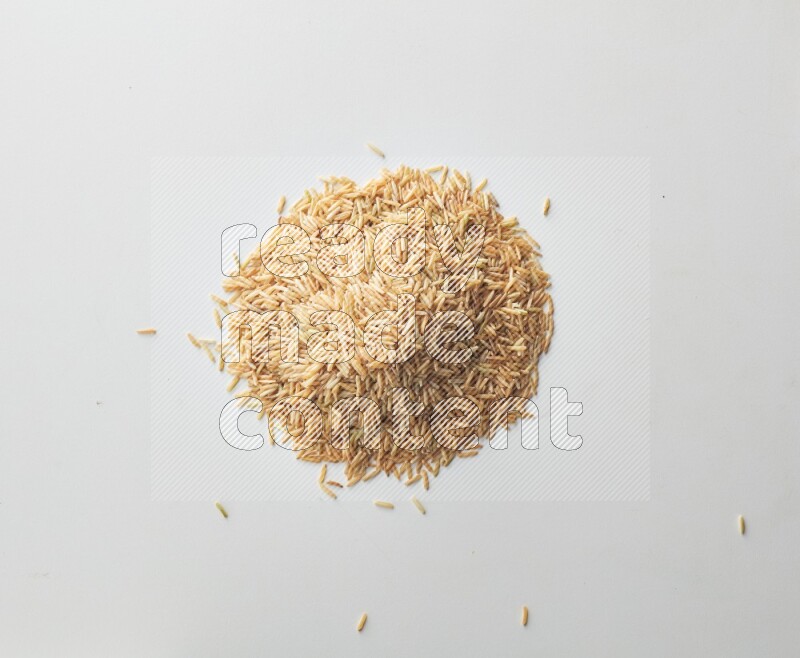 Top-view shot of long grain brown rice on white background