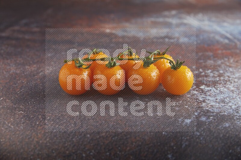 Orange cherry tomato vein on reddish rustic metal background 45 degree