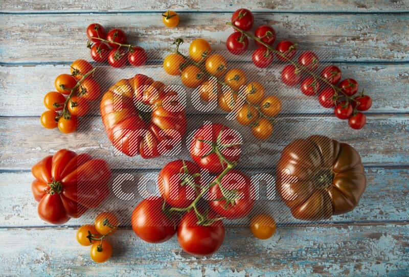 Mixed Tomatoes types topview on a textured vinyl backgrounds