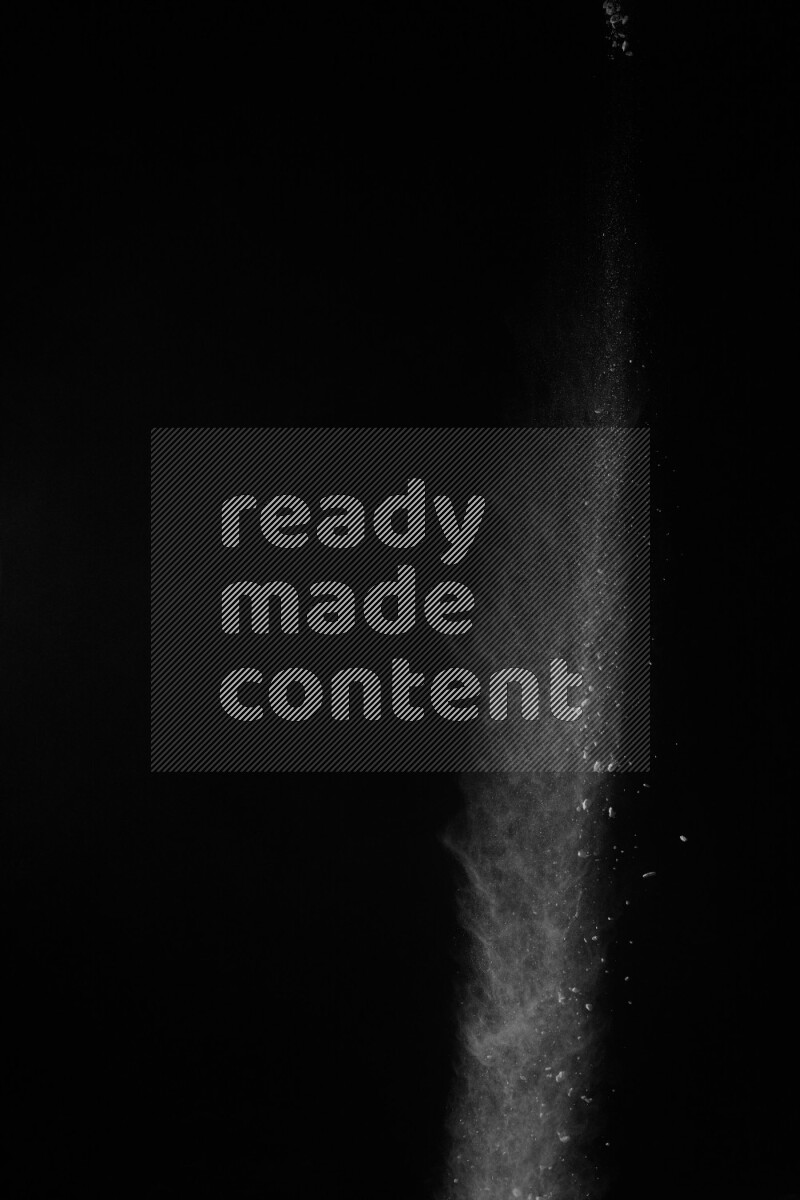 A side view of white powder explosion on black background