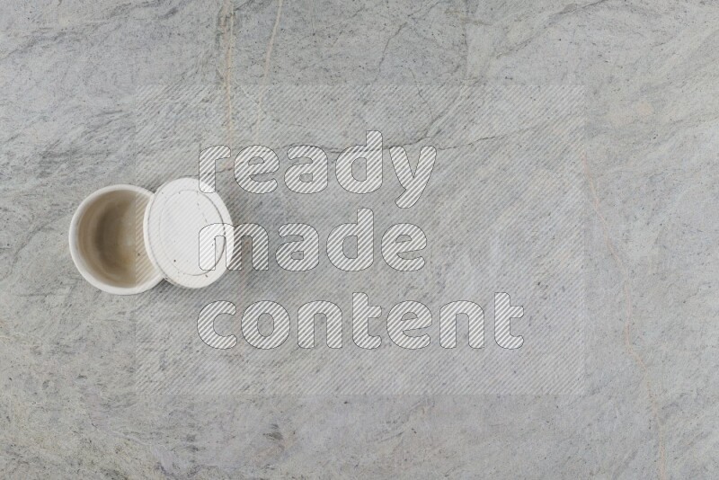 A multicolored pottery Cup on grey marble background
