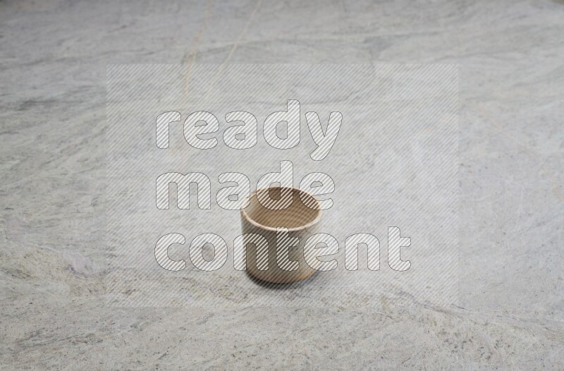 A multicolored pottery Cup on grey marble background