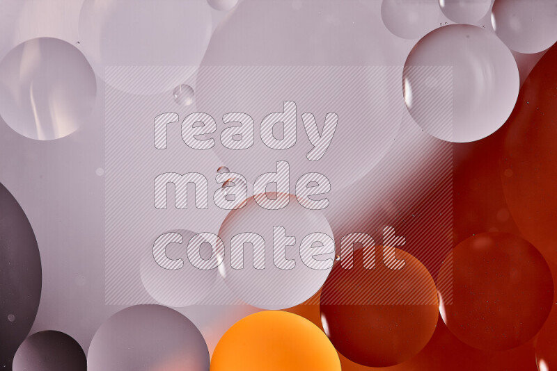 Close-ups of abstract oil bubbles on water surface in shades of white and orange
