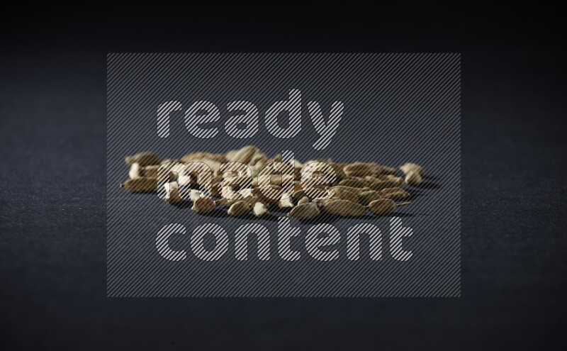 Cardamom seeds on black flooring