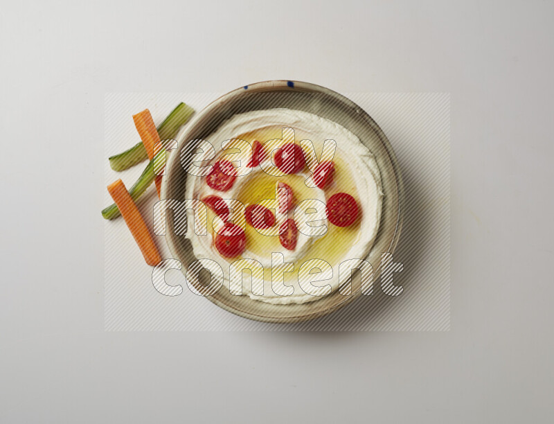 Lebnah garnished with cherry tomato in a grey pottery plate on a white background