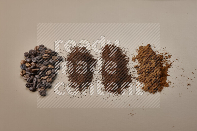 Assorted kinds of coffee such as roasted beans and ground on beige background