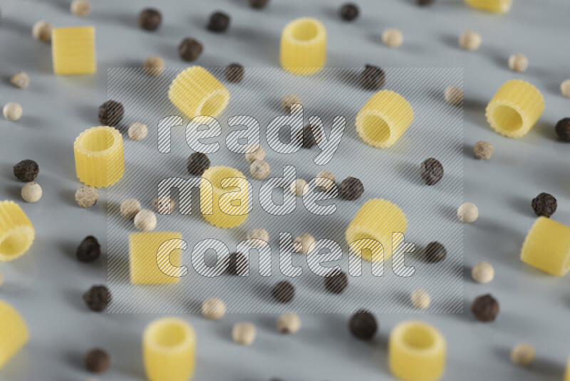 معكرونة مع مكونات متنوعة من الطماطم والثوم والبصل والفلفل الأحمر والفلفل الأسود والفلفل الأبيض وأوراق الغار وإكليل الجبل والهيل و مشروم على خلفية زرقاء فاتحة