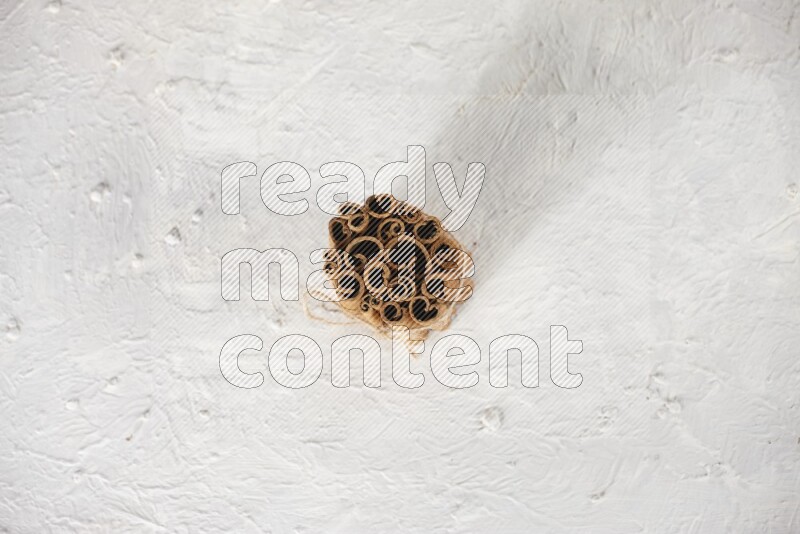 A bounded stack of cinnamon sticks on white background