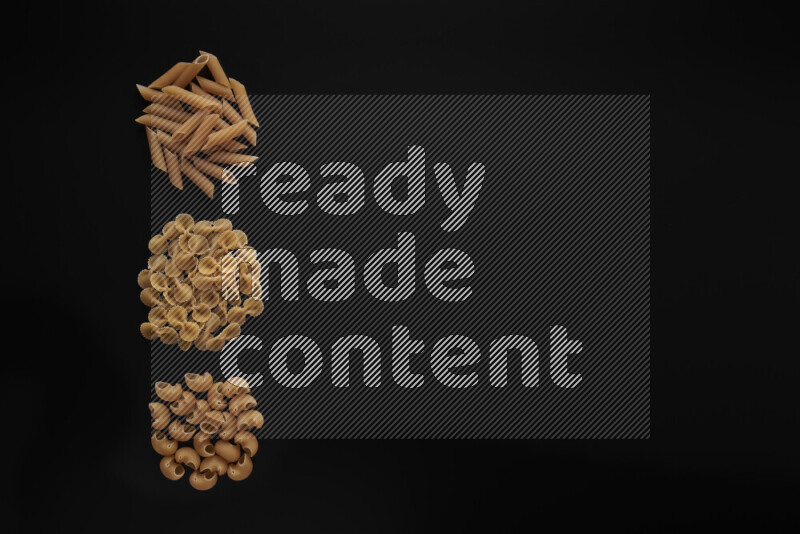Different pasta types in 3 bunches on black background
