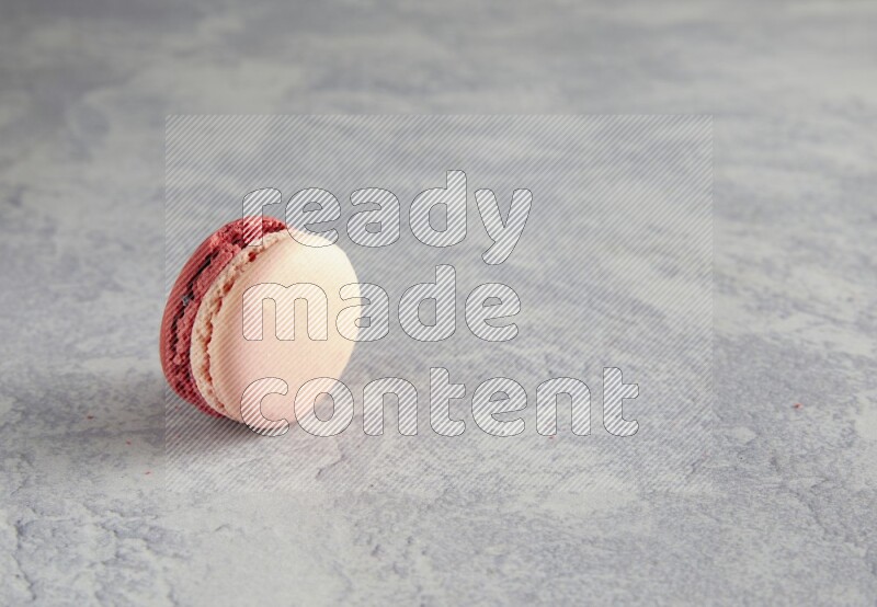 45º Shot of Pink Litchi Raspberry macaron on white  marble background