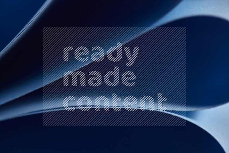 An abstract art showing blue paper sheets arranged in an overlapping curves