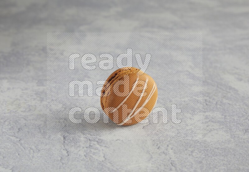 45º Shot of Brown Irish Cream macaron on white marble background