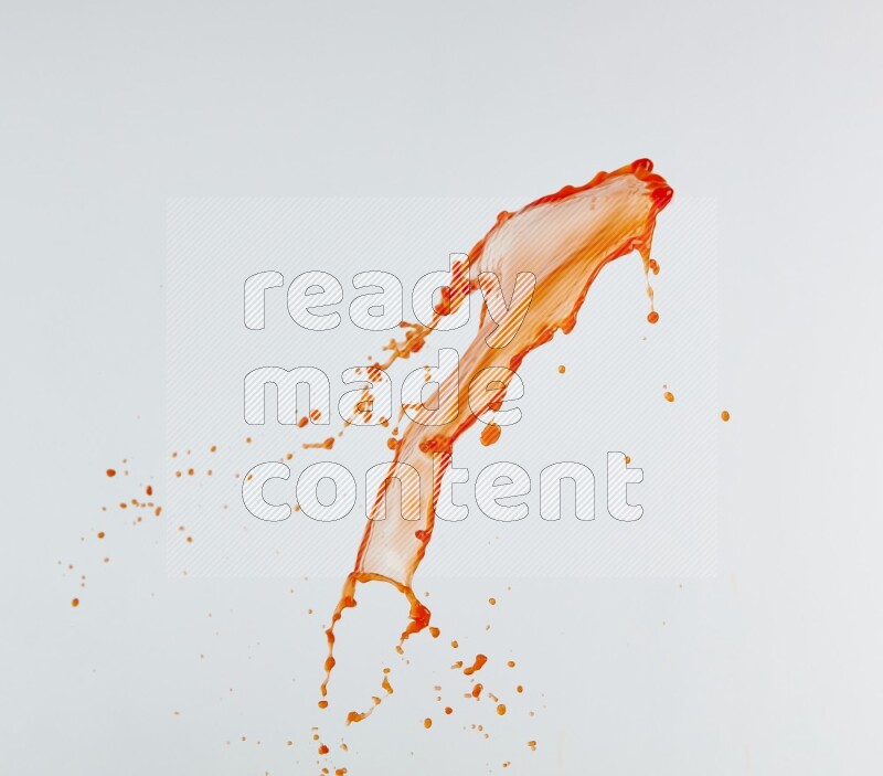 Orange liquid splash and drops on white background