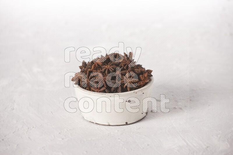 Star Anise in a white bowl on white background