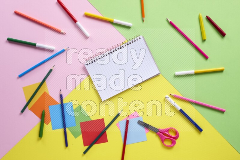 Different school supplies on multicolored background