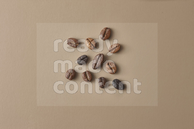 Roasted coffee beans on beige background