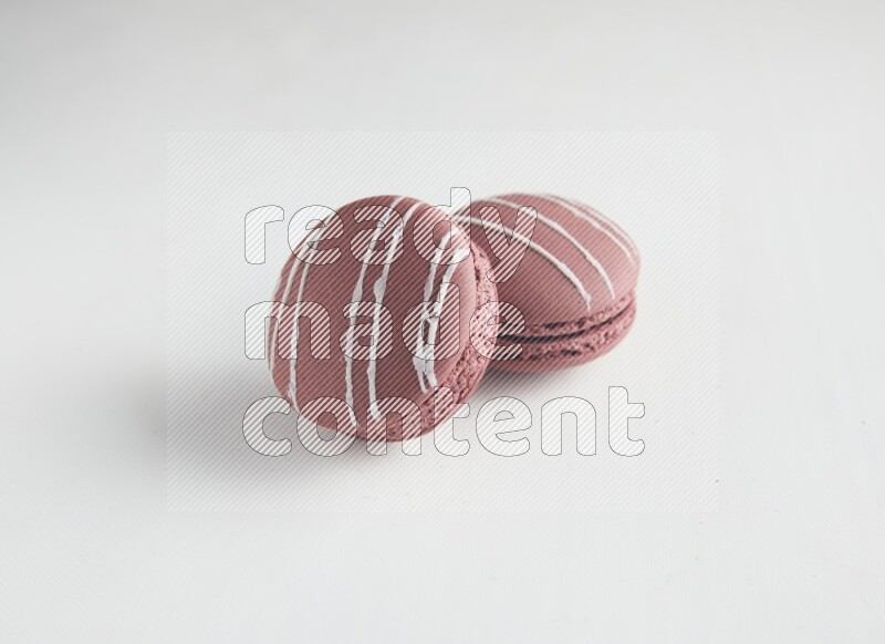 45º Shot of two Red Poppy Flower macarons on white background