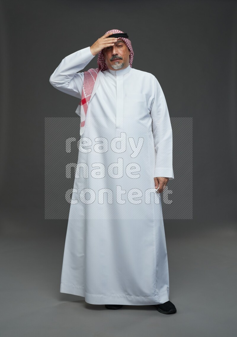 Saudi man with shomag Standing feeling sick on gray background