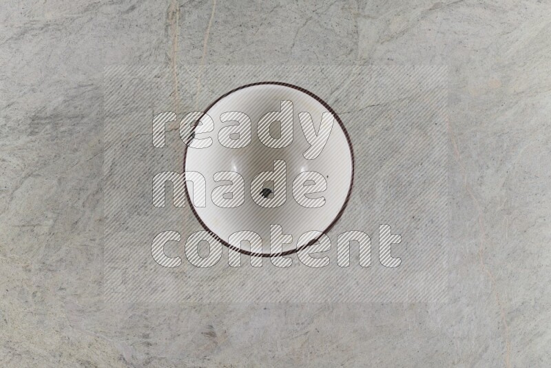 A vintage metal pot on grey marble background