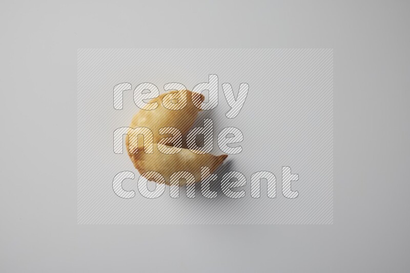 Two fried sambosa from a top angle on a white background