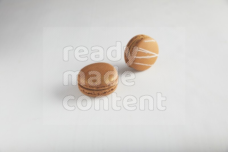 45º Shot of of two assorted Brown Irish Cream, and Brown Coffee macarons  on white background