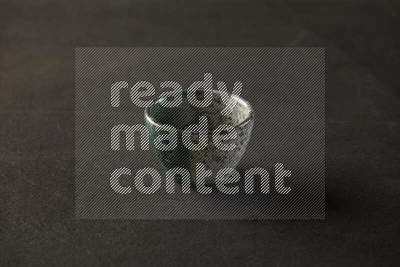 multi color round sauce bowl on grey textured countertop