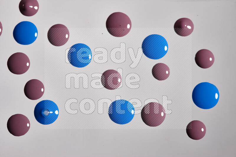 Close-ups of abstract purple and blue paint droplets on the surface