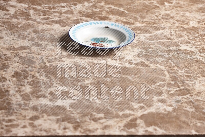A vintage metal plate on beige marble background