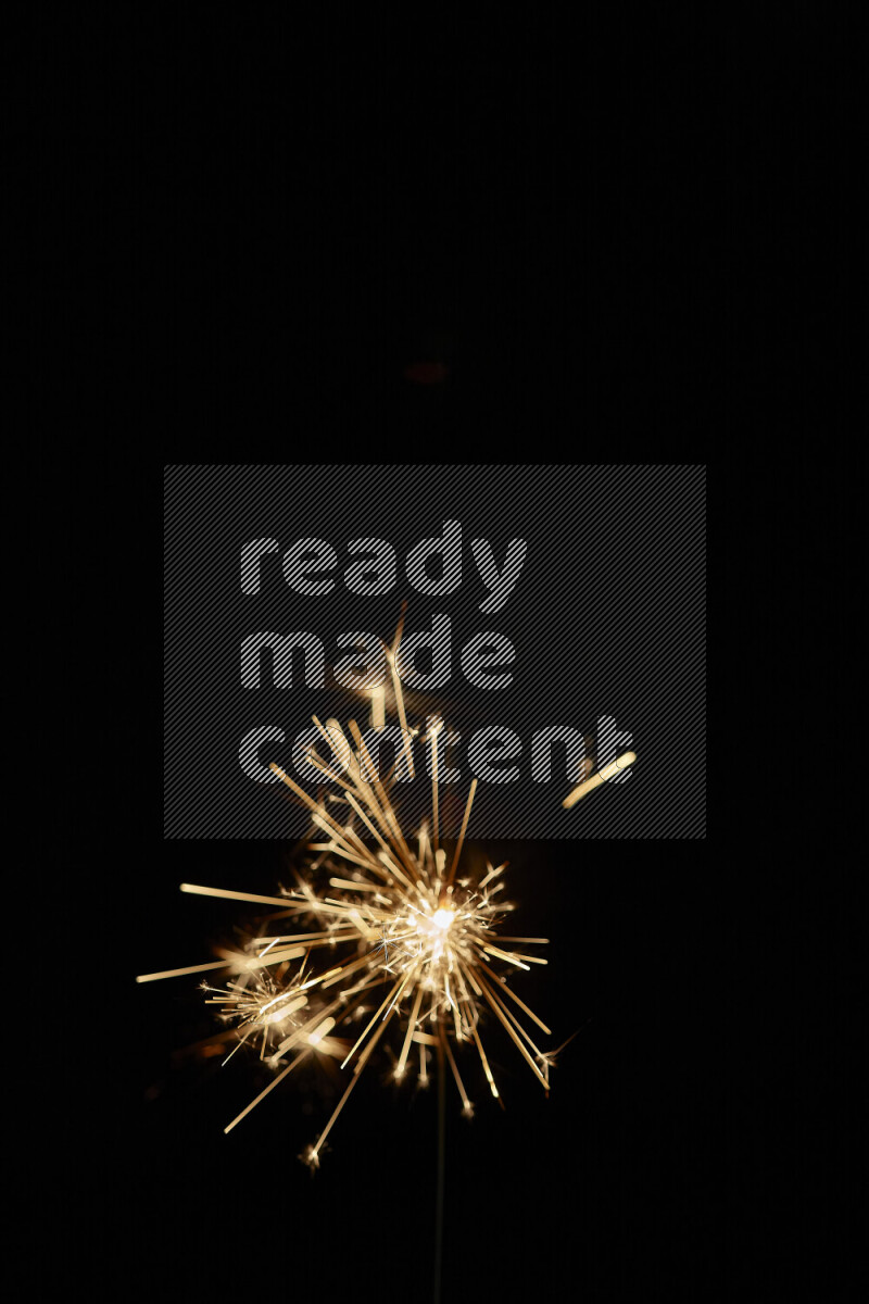 A close-up image of sparkler candle isolated on black background