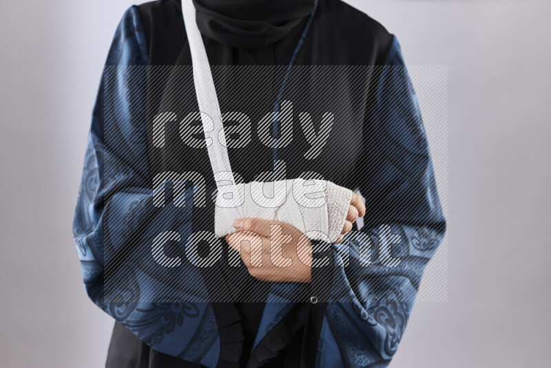 Woman with a bandaged hand and arm sling