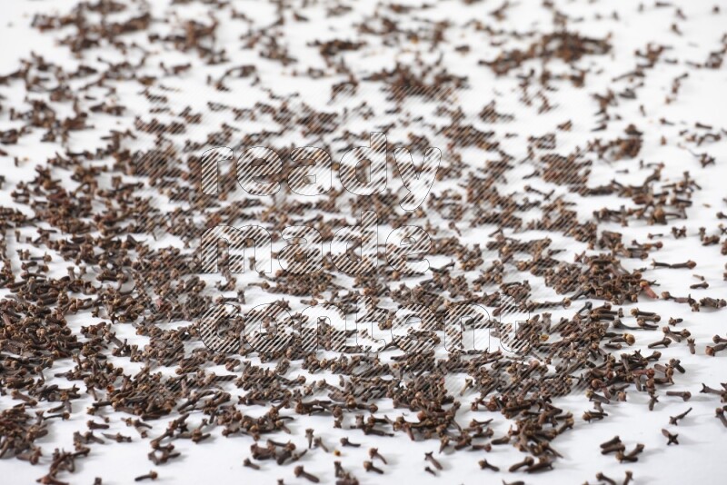 Cloves spread on white flooring