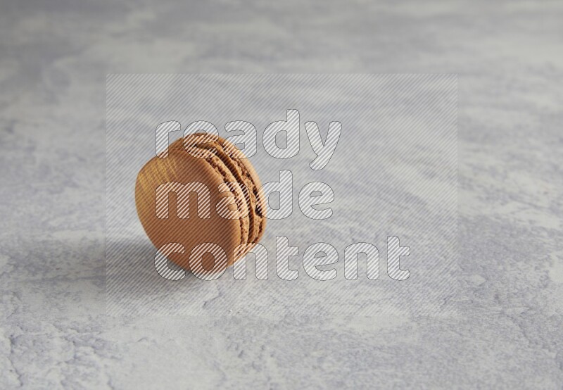 45º Shot of Brown Coffee macaron on white  marble background