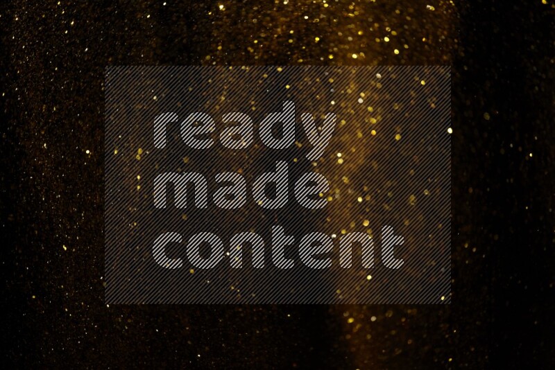 Gold glitter powder isolated on black background