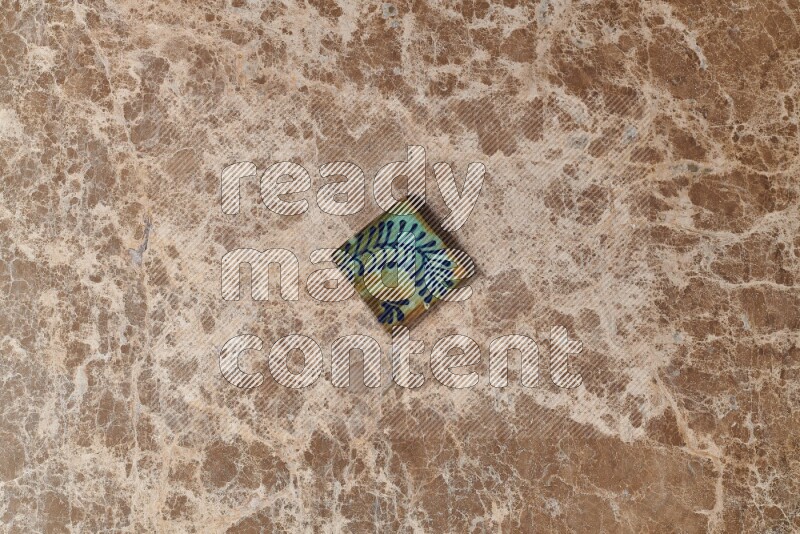 A decorative coaster on beige marble background