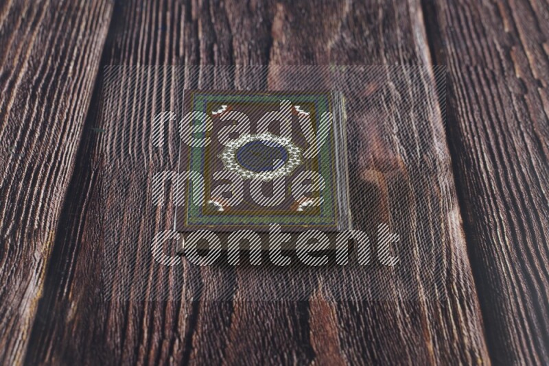 Quran with a prayer beads on wooden background