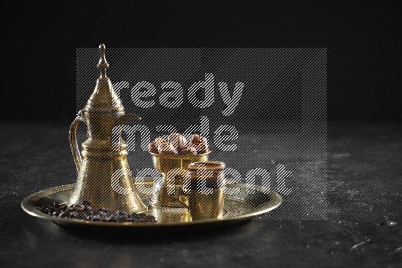 Dates with a drink on a metal tray in a dark setup