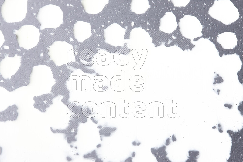 Close-ups of abstract white paint droplets on the surface