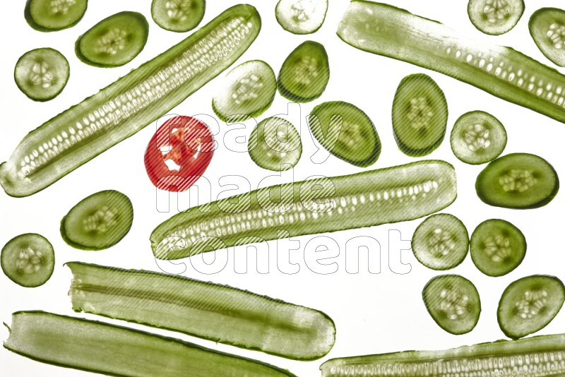 Mixed vegetables slices on illuminated white background