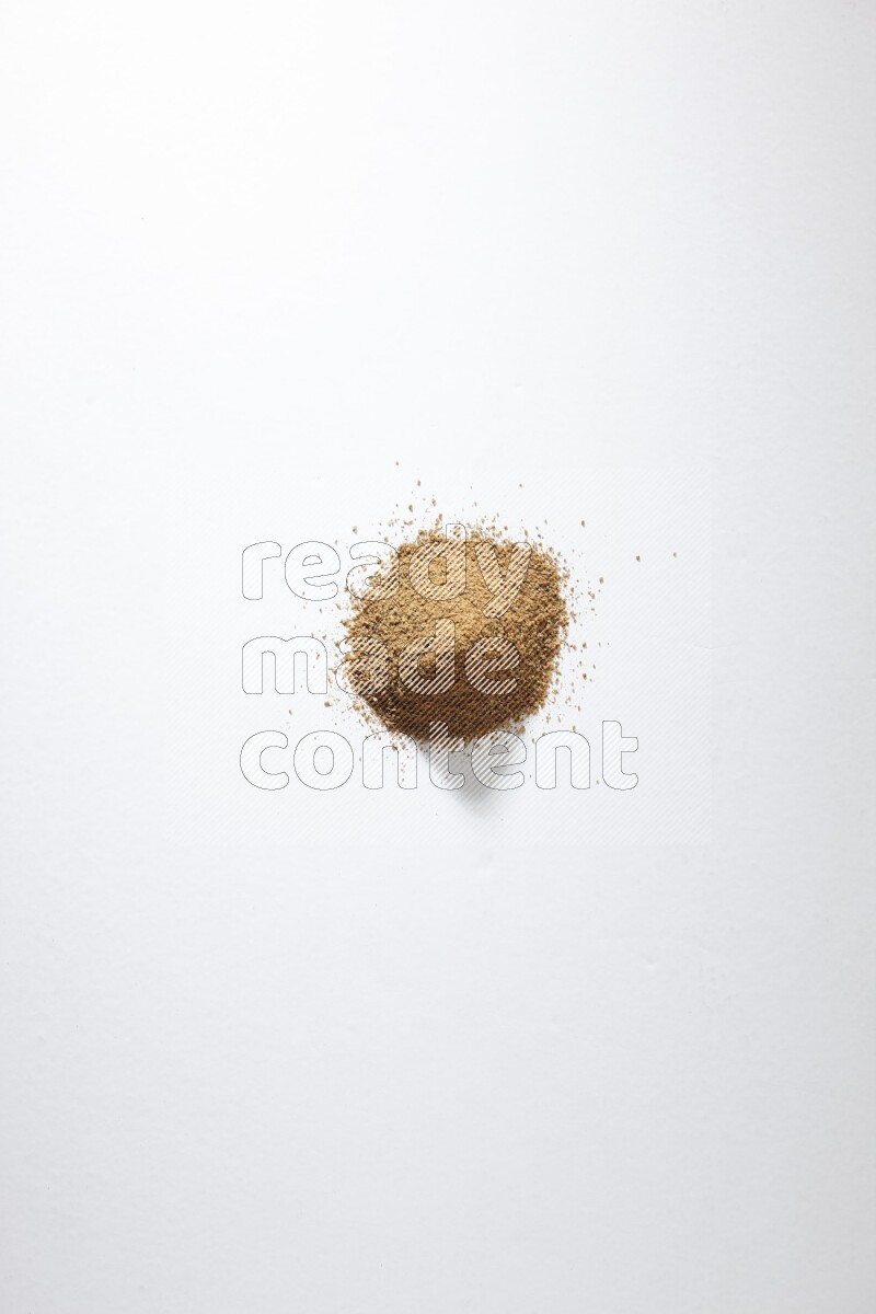 Cumin powder on white flooring
