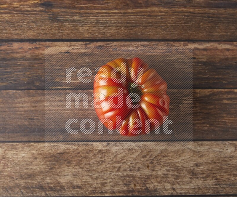 Single topview Heiloom Tomato on a wooden background
